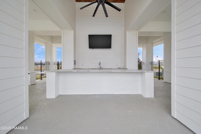 view of patio with a ceiling fan and fence