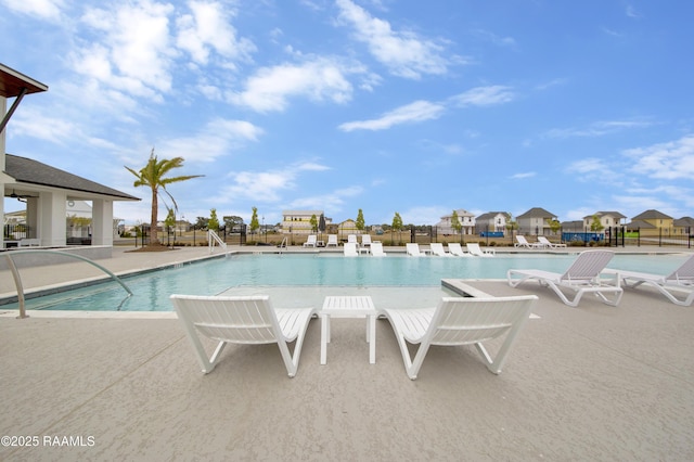 community pool featuring a patio and fence