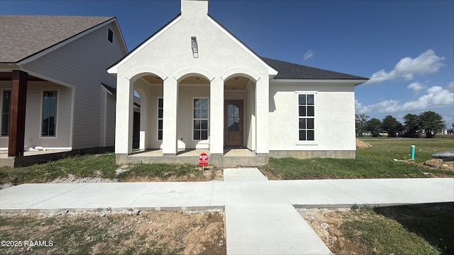 211 Keystone Dr, Scott, LA 70583 - view of front facade featuring a porch, a shingled roof, stucco siding, and a chimney