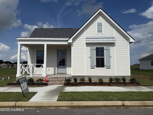 205 Keystone Dr, Scott, LA 70583 - view of front of home with board and batten siding, covered porch, a standing seam roof, and a metal roof