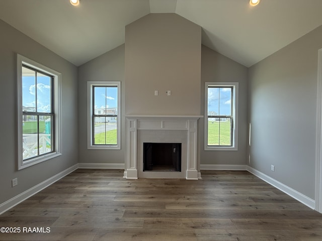 205 Keystone Dr, Scott, LA 70583 - unfurnished living room with lofted ceiling, healthy amount of natural light, a fireplace, wood finished floors, and recessed lighting