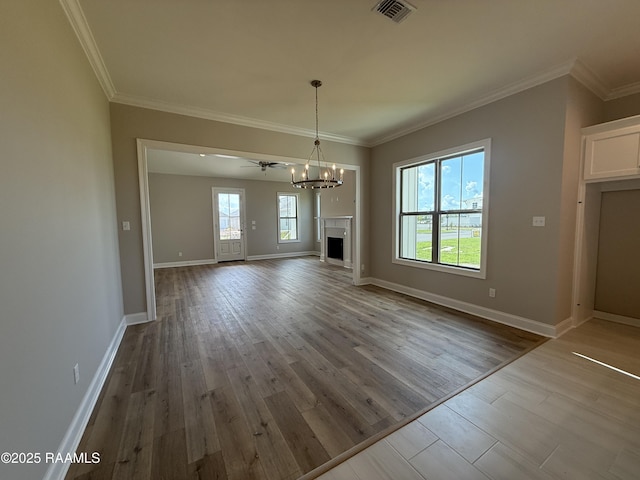 205 Keystone Dr, Scott, LA 70583 - unfurnished living room with a chandelier, wood finished floors, ornamental molding, and a fireplace