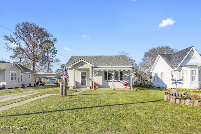 bungalow with central AC unit, a front yard, and a carport