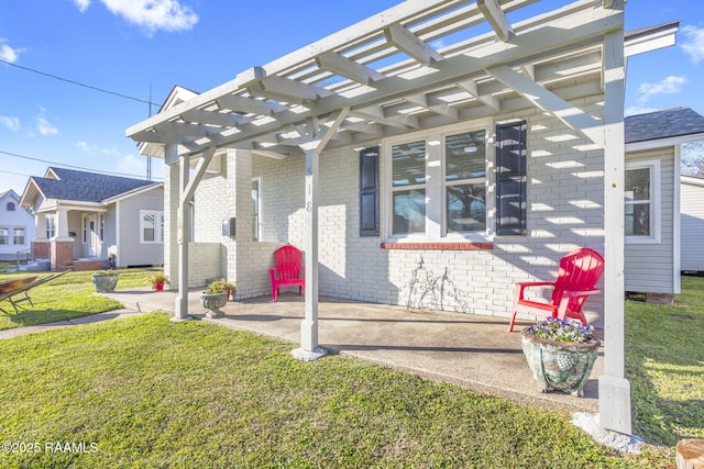 view of front of home featuring brick siding, a pergola, and a front lawn