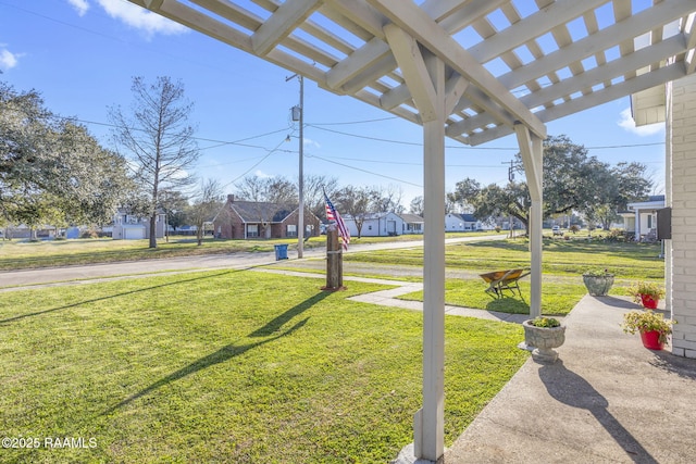 view of yard featuring a pergola and a residential view