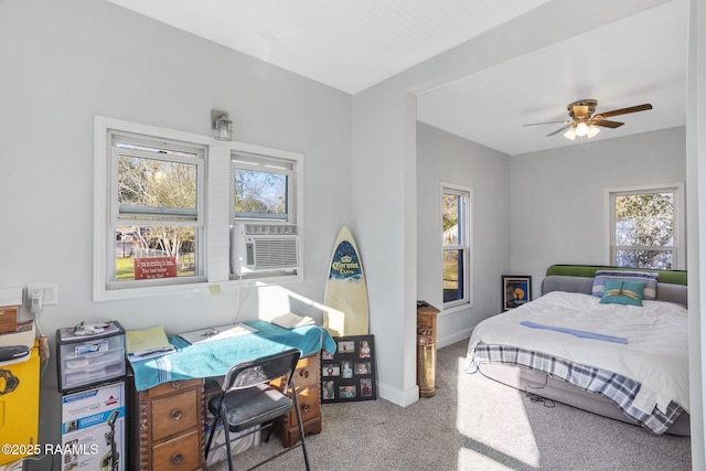 carpeted bedroom with baseboards, cooling unit, and a ceiling fan