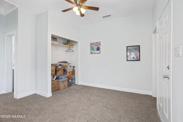 interior space with a closet, baseboards, visible vents, and carpet