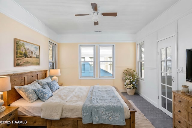 bedroom with a ceiling fan, visible vents, multiple windows, and carpet