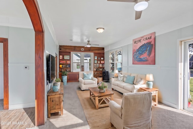 living room featuring a ceiling fan and light carpet