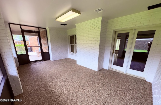 unfurnished sunroom featuring visible vents and french doors
