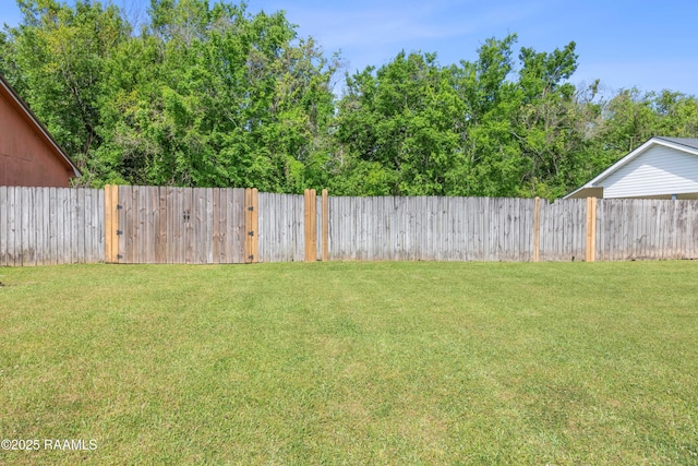 view of yard with a fenced backyard