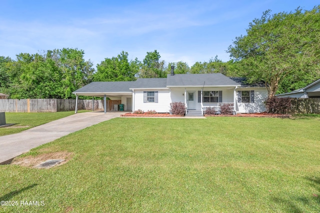 ranch-style home featuring concrete driveway, fence, and a front lawn