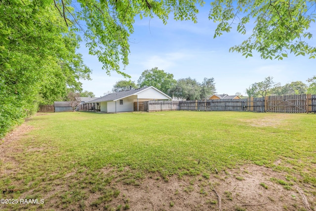 view of yard with a fenced backyard