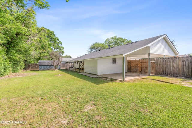 back of property with a patio, a yard, and a fenced backyard