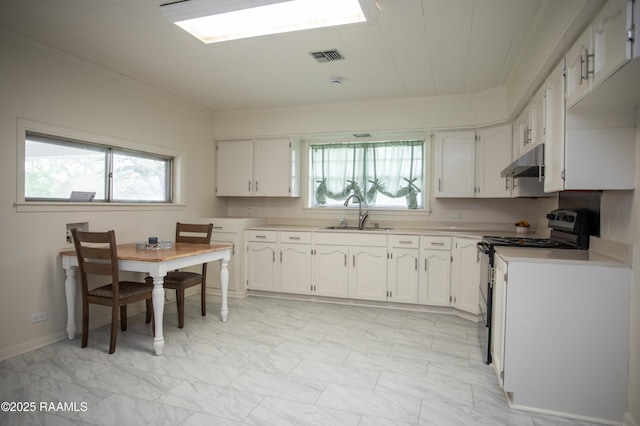 4189 Poydras Hwy, Breaux Bridge, LA 70517 - kitchen featuring light countertops, ornamental molding, under cabinet range hood, a sink, and black range with electric cooktop