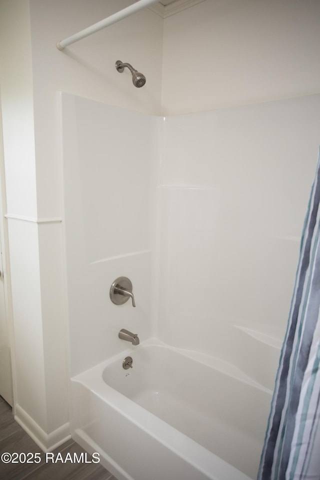 4189 Poydras Hwy, Breaux Bridge, LA 70517 - full bathroom featuring wood finished floors and shower / bath combo with shower curtain