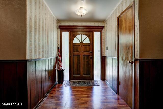 1217 Wellington Ave, Opelousas, LA 70570 - entryway with wainscoting, wallpapered walls, and wood finished floors