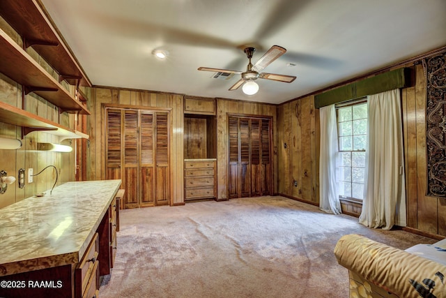 1217 Wellington Ave, Opelousas, LA 70570 - interior space with light colored carpet, wooden walls, and ceiling fan