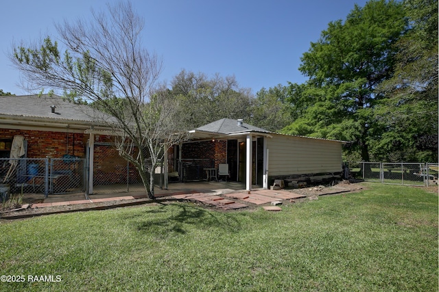 1217 Wellington Ave, Opelousas, LA 70570 - back of house featuring a yard, a patio, fence, and a gate