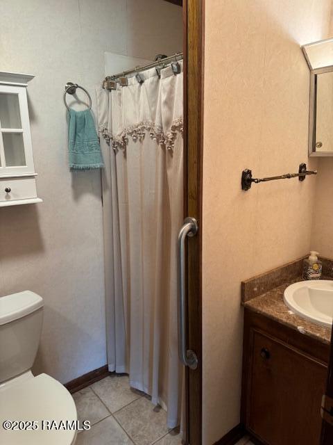 1217 Wellington Ave, Opelousas, LA 70570 - bathroom with toilet, tile patterned flooring, vanity, and curtained shower