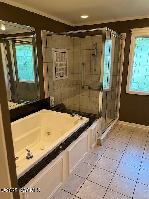 1217 Wellington Ave, Opelousas, LA 70570 - bathroom featuring a stall shower, tile patterned flooring, a tub with jets, and crown molding