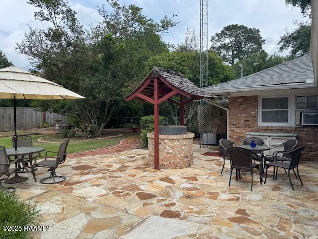 1217 Wellington Ave, Opelousas, LA 70570 - view of patio / terrace featuring a gazebo, cooling unit, outdoor dining area, and fence