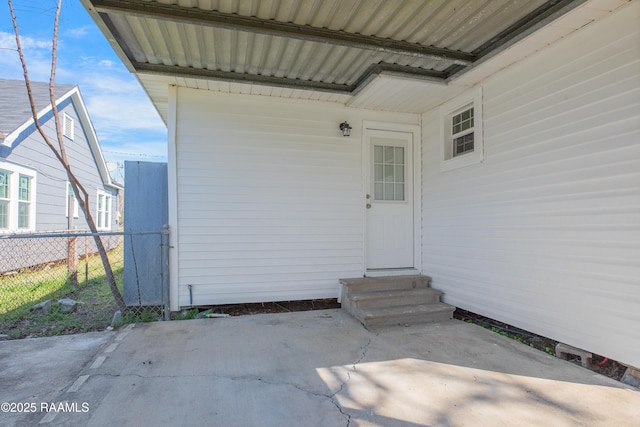 doorway to property with fence and a patio