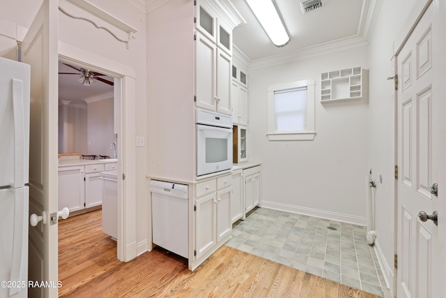 kitchen featuring crown molding, white cabinetry, white appliances, and visible vents
