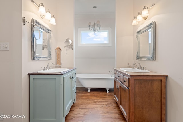 full bathroom with a sink, two vanities, and an inviting chandelier