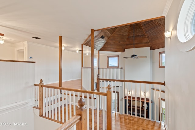 hall with crown molding, a wealth of natural light, an upstairs landing, and wooden ceiling