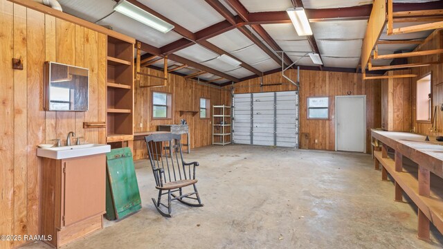 garage with wood walls and a sink
