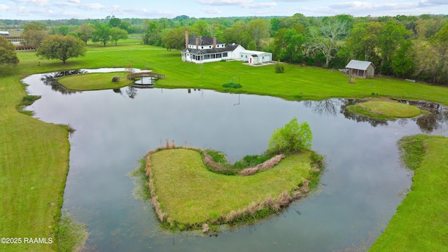 drone / aerial view featuring a water view and a forest view