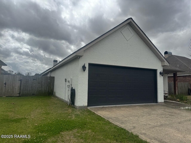 114 Sandhill Crane Dr, Lafayette, LA 70508 - view of side of home with fence, an attached garage, brick siding, and concrete driveway