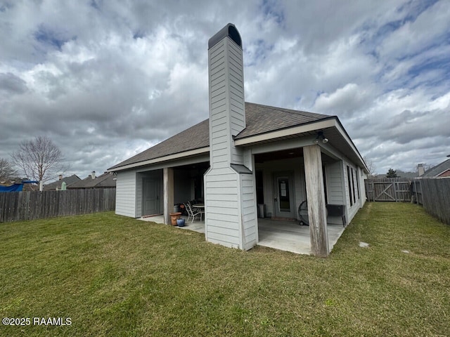 114 Sandhill Crane Dr, Lafayette, LA 70508 - back of house with a fenced backyard, roof with shingles, a patio, and a yard