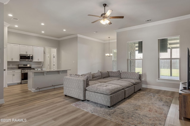 living area featuring light wood-style floors, recessed lighting, ceiling fan with notable chandelier, and visible vents