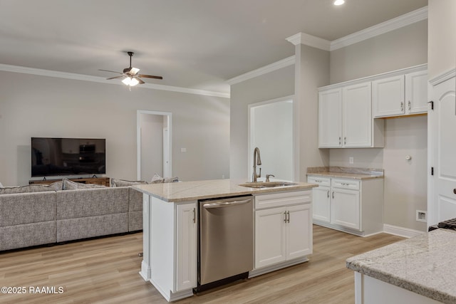 kitchen with stainless steel dishwasher, a sink, light wood finished floors, open floor plan, and white cabinetry