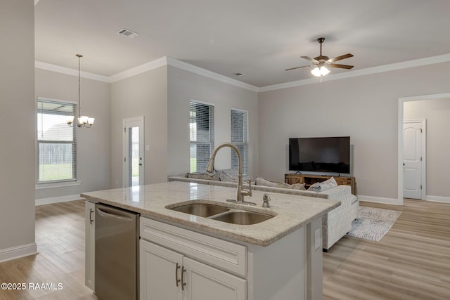 kitchen featuring open floor plan, a sink, light wood-style flooring, and dishwasher