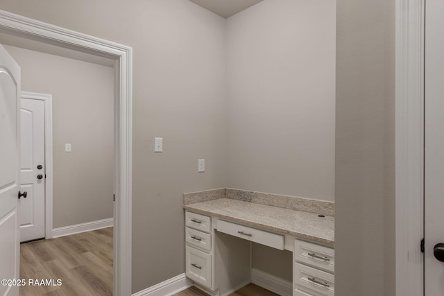bathroom featuring baseboards and wood finished floors