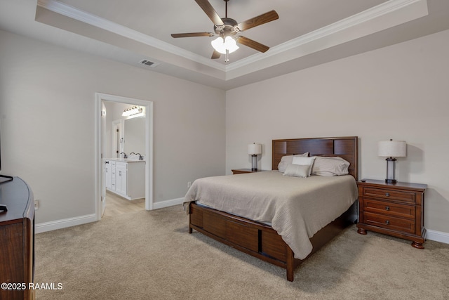 bedroom with crown molding, baseboards, light carpet, and a raised ceiling