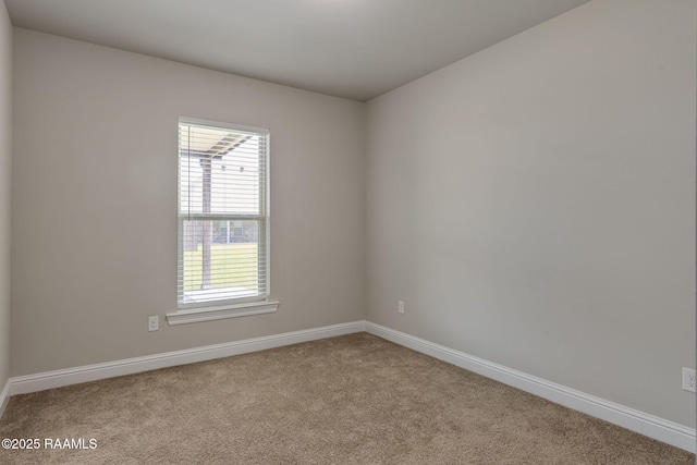 empty room featuring a healthy amount of sunlight, baseboards, and carpet flooring
