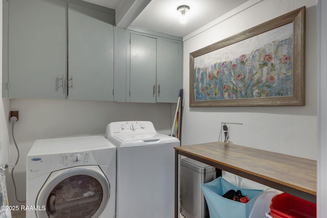 clothes washing area with cabinet space and washer and clothes dryer