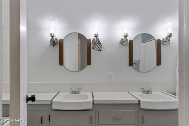 full bath with a sink and double vanity