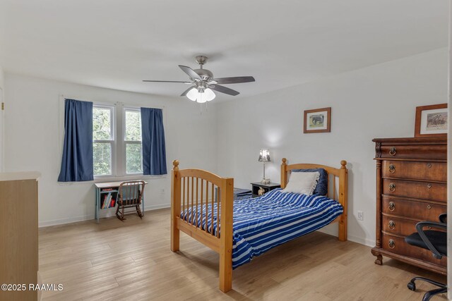 bedroom with baseboards, a ceiling fan, and wood finished floors