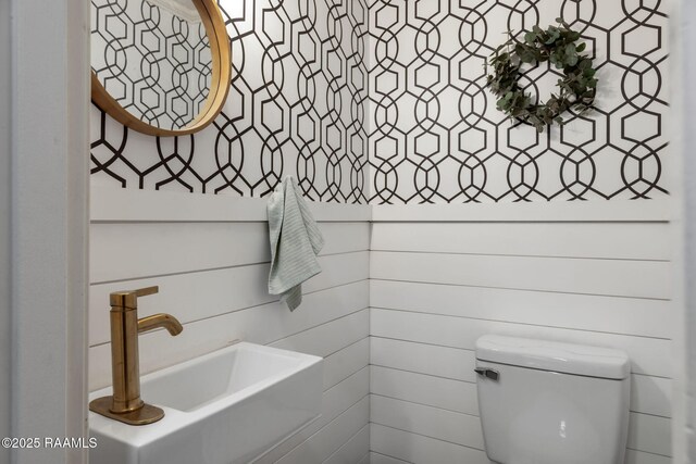 half bathroom with toilet and a sink