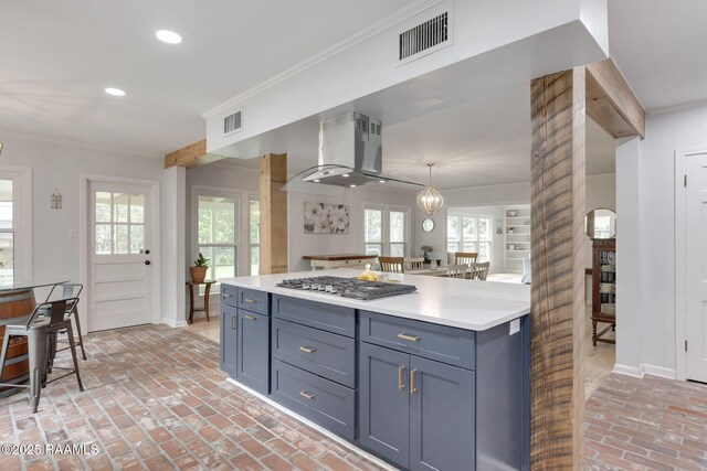 kitchen featuring stainless steel gas stovetop, brick floor, extractor fan, and visible vents