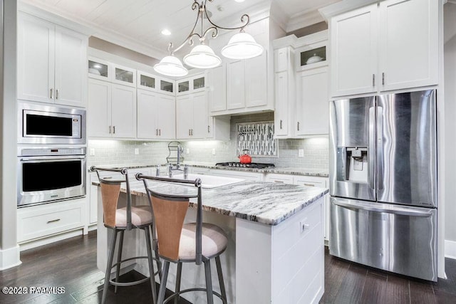311 Oats Dr, Lafayette, LA 70508 - kitchen featuring stainless steel appliances, an island with sink, dark wood finished floors, white cabinetry, and glass insert cabinets