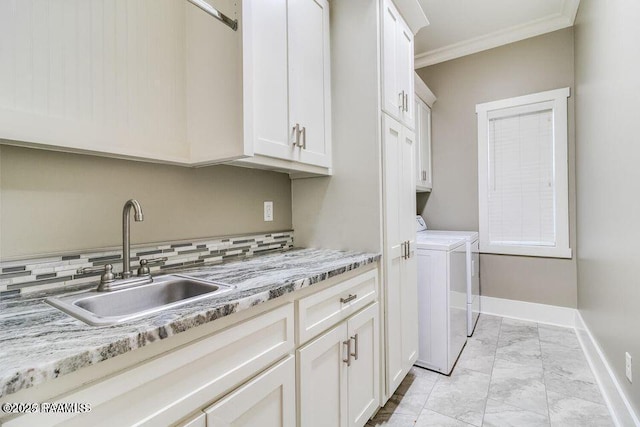 311 Oats Dr, Lafayette, LA 70508 - washroom featuring cabinet space, washer and dryer, light marble finish flooring, ornamental molding, and baseboards