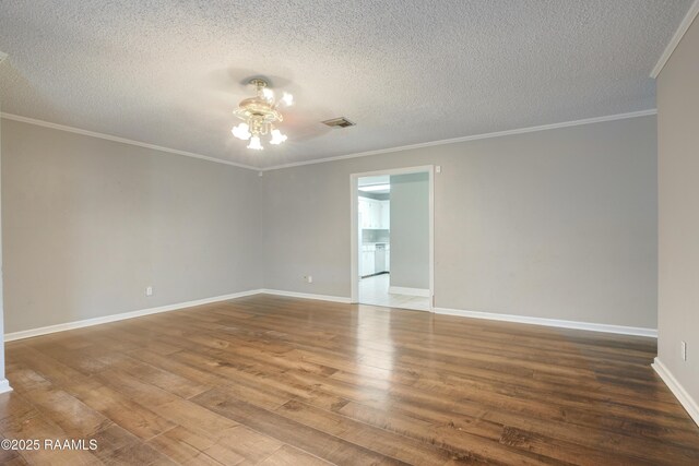 1406 S Patout St, New Iberia, LA 70560 - empty room with a textured ceiling, visible vents, wood finished floors, baseboards, and ornamental molding