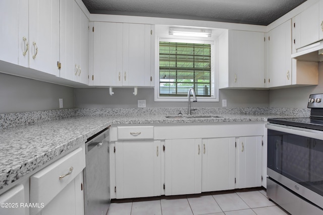 1406 S Patout St, New Iberia, LA 70560 - kitchen with light countertops, a sink, light tile patterned floors, and stainless steel appliances