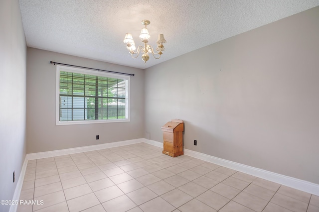 1406 S Patout St, New Iberia, LA 70560 - unfurnished room featuring baseboards, light tile patterned flooring, a textured ceiling, and a chandelier
